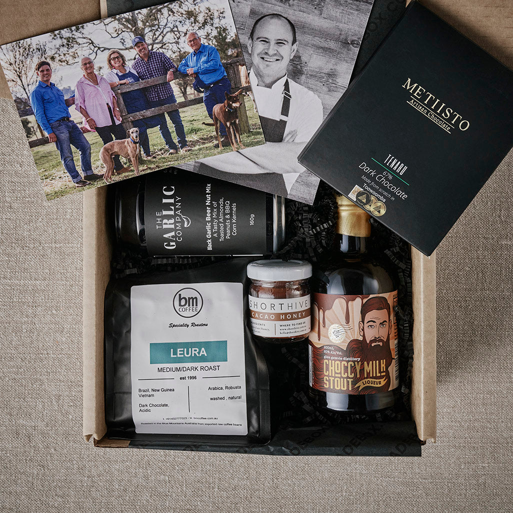 Gift hamper featuring artisanal food products, dark chocolate, coffee, and a stout beer from local Australian makers.