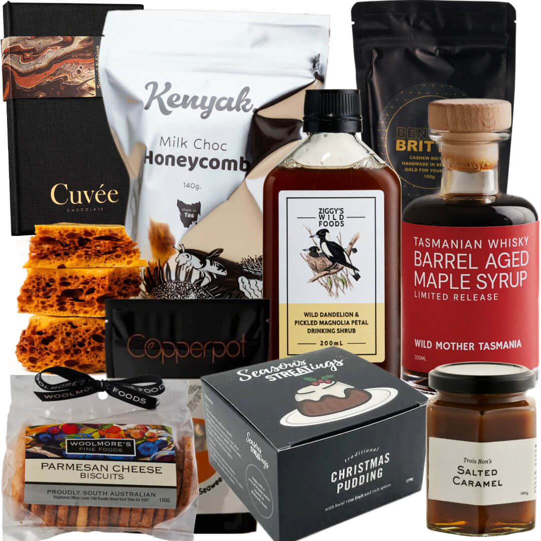 Assorted gourmet gift box with honeycomb, cheese biscuits, salted caramel, maple syrup, and Christmas pudding.