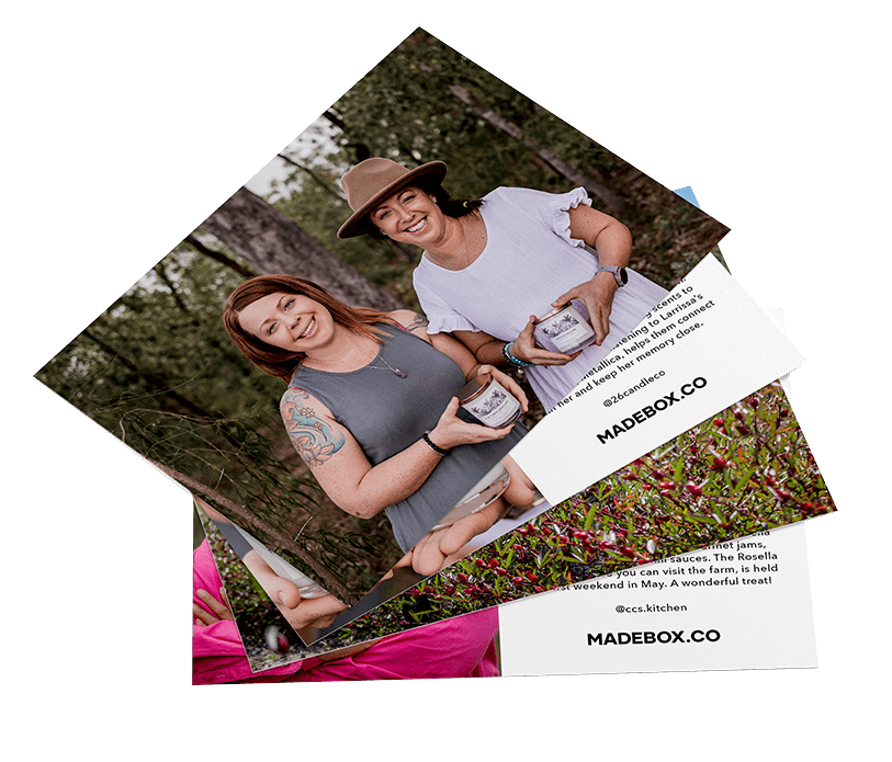 Two women smiling outdoors with gift boxes, promoting wellbeing products for MadeBox.