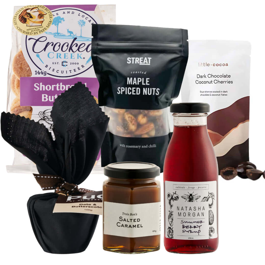 Xmas Fun Box featuring cookies, spiced nuts, chocolate cherries, salted caramel, and summer beetroot syrup for festive gifting.