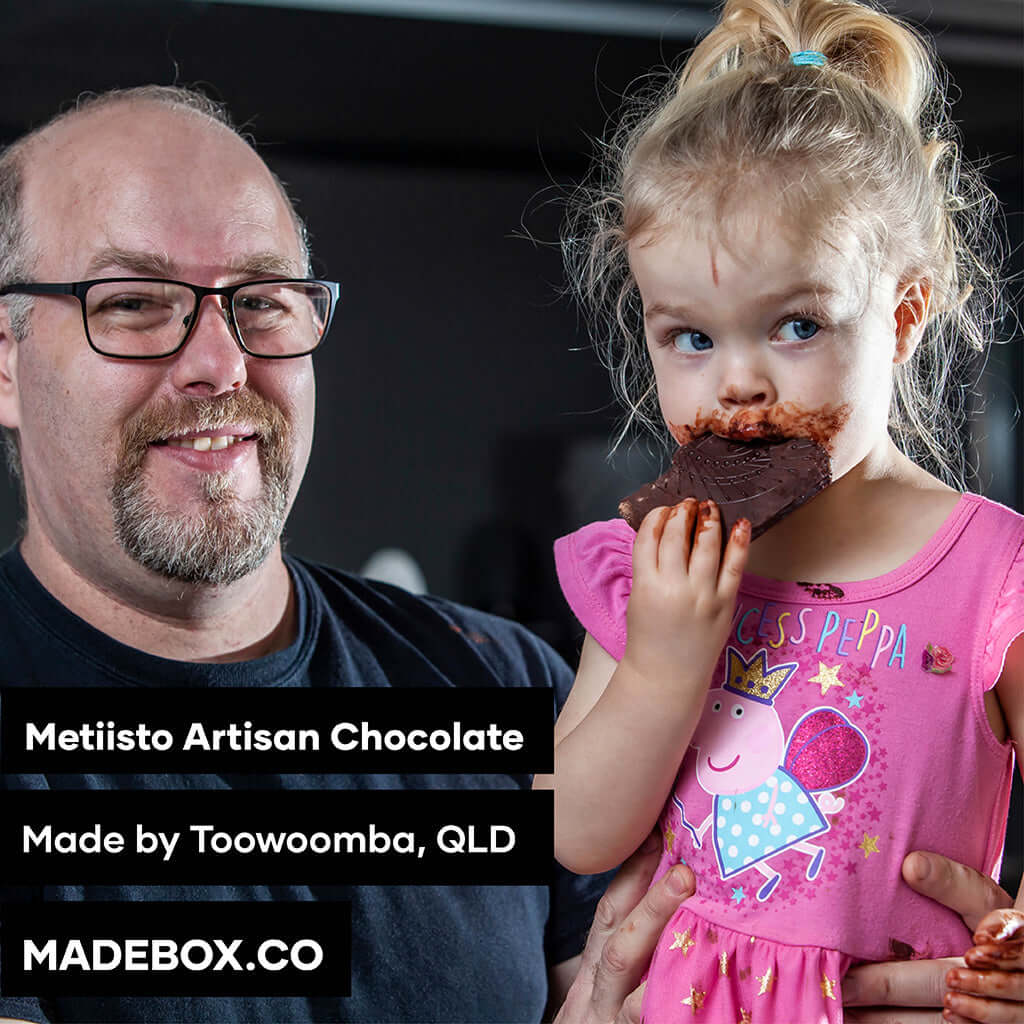 Enjoying Metiisto Artisan Chocolate with a child, a delightful treat crafted in Toowoomba, QLD.