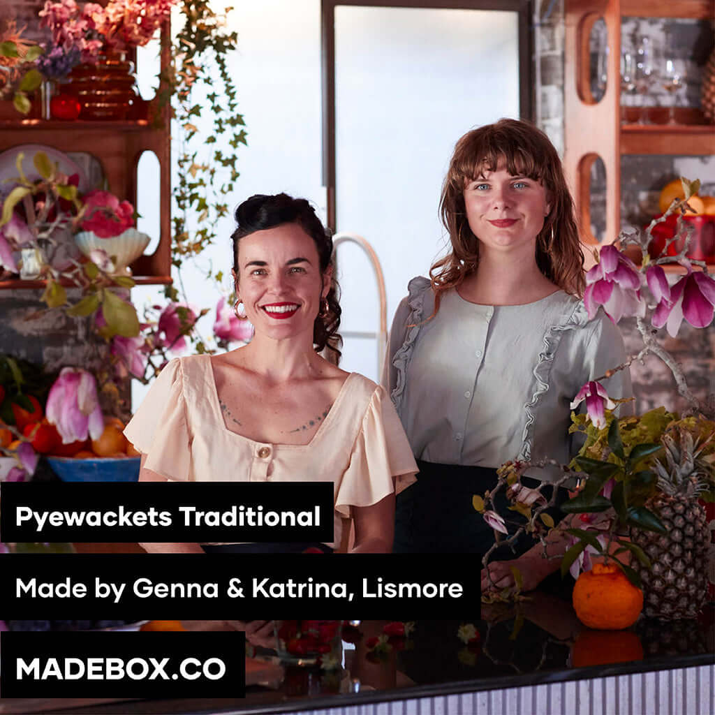 Two women showcasing Pyewackets Traditional products in a floral setting, crafted in Lismore.