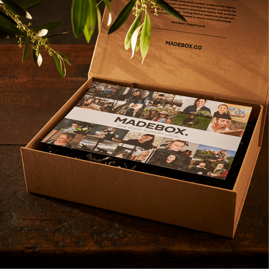 Open sustainability gift box featuring local products and a personalized message, showcasing community support.