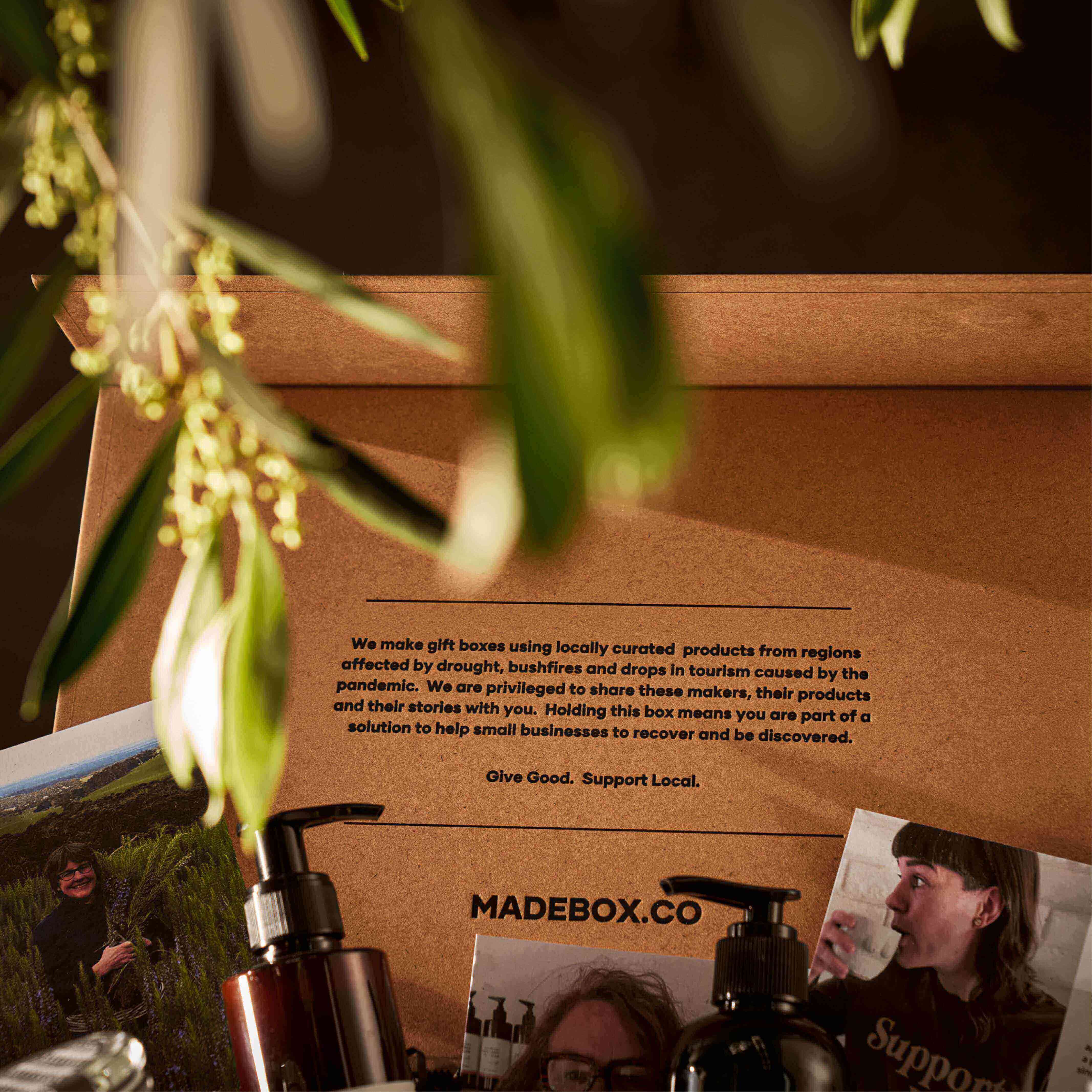 Locally curated gift box with products supporting Australian businesses, displayed with greenery.