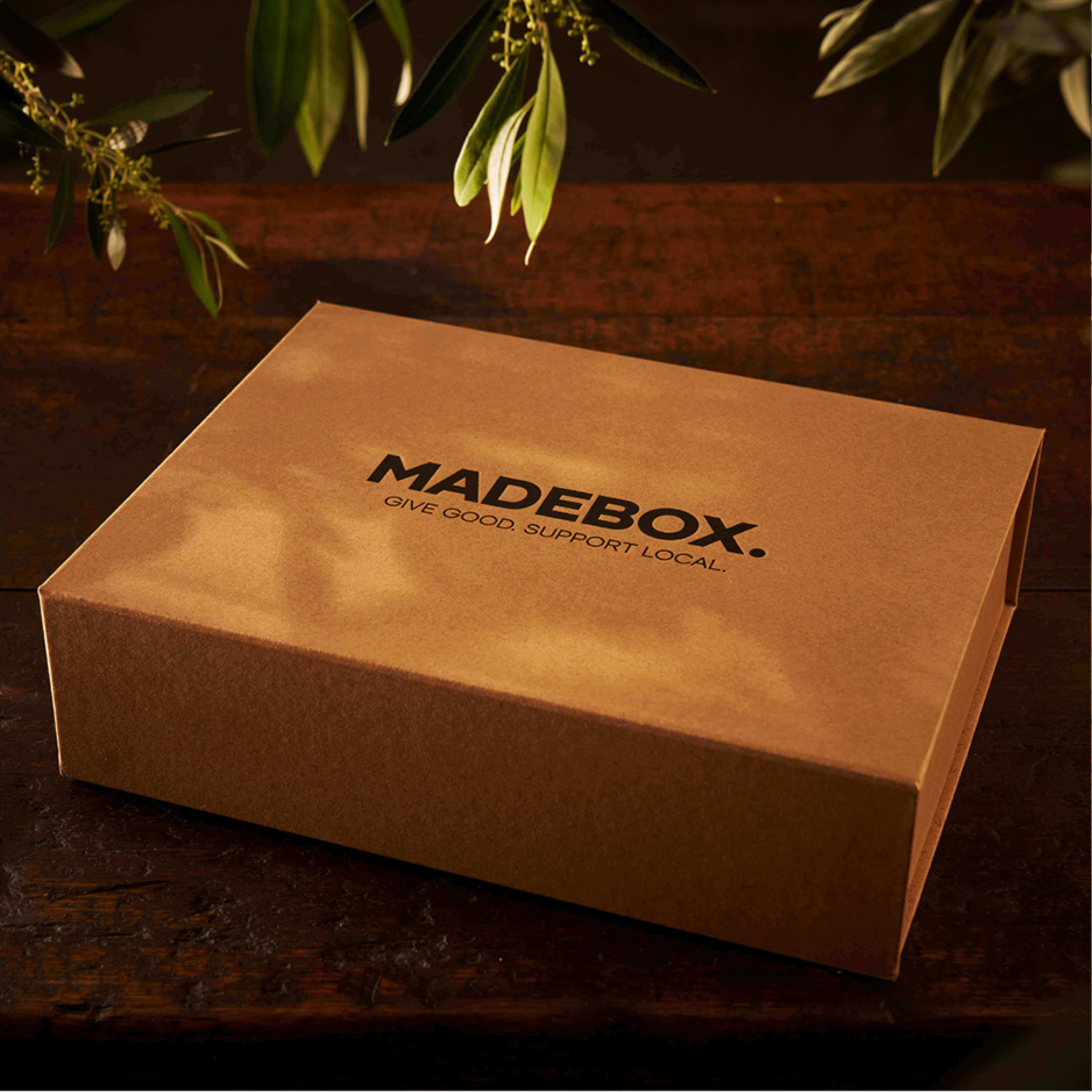 MADEBOX gift box on a wooden table, ideal for local and thoughtful gifting.