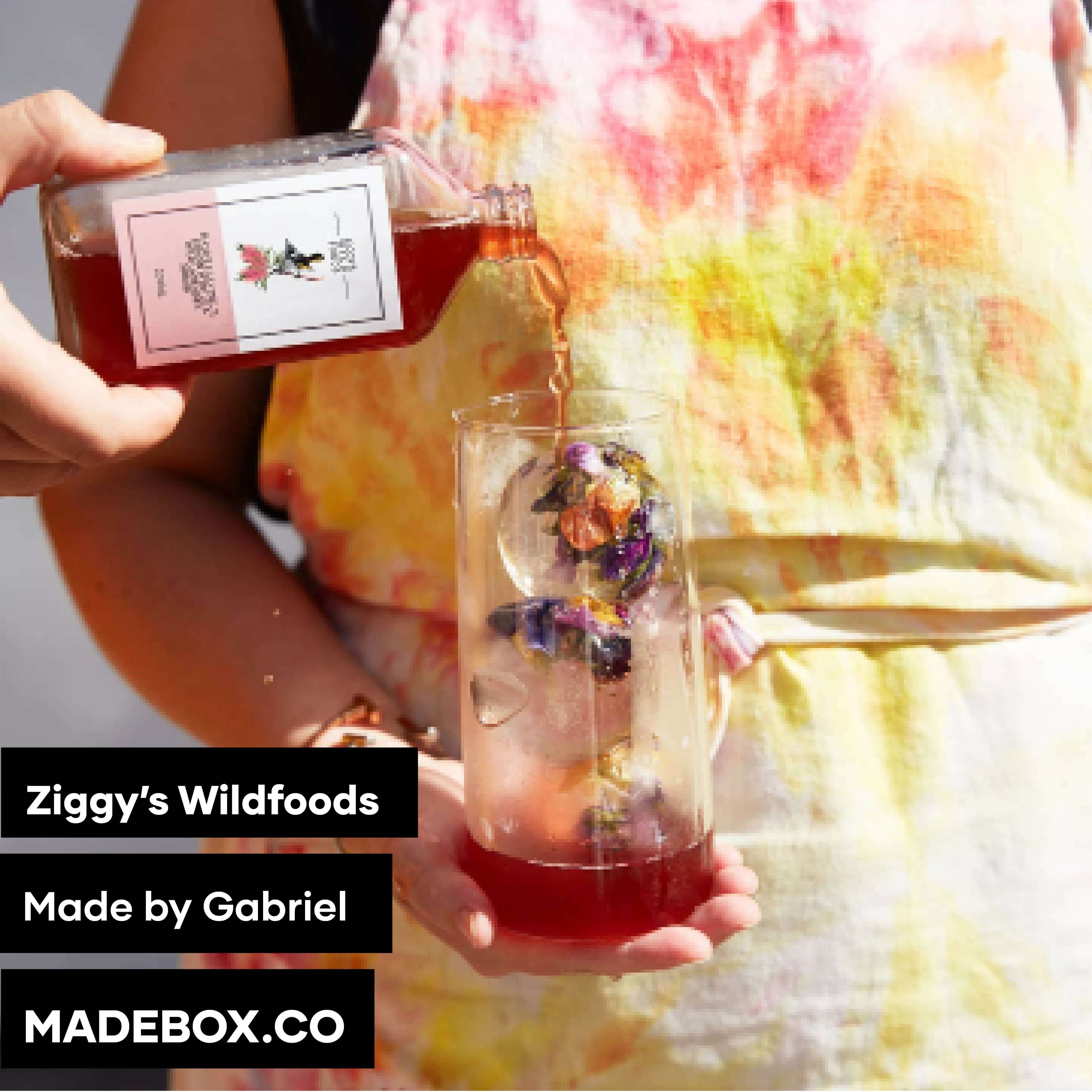 Person pouring herbal tea into a glass with flowers, featuring Ziggy's Wildfoods by Gabriel.