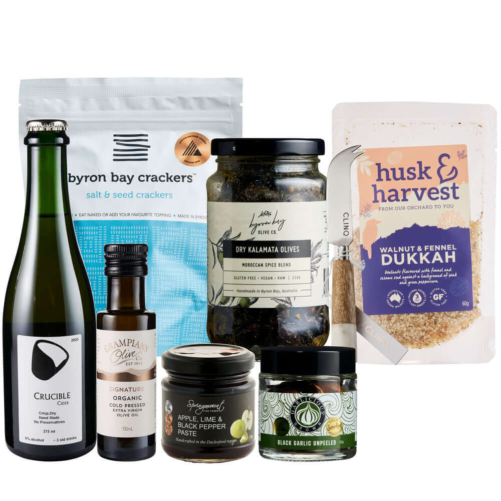 Gourmet gift box featuring Byron Bay crackers, Kalamata olives, dukkah, and other premium snacks in elegant packaging.