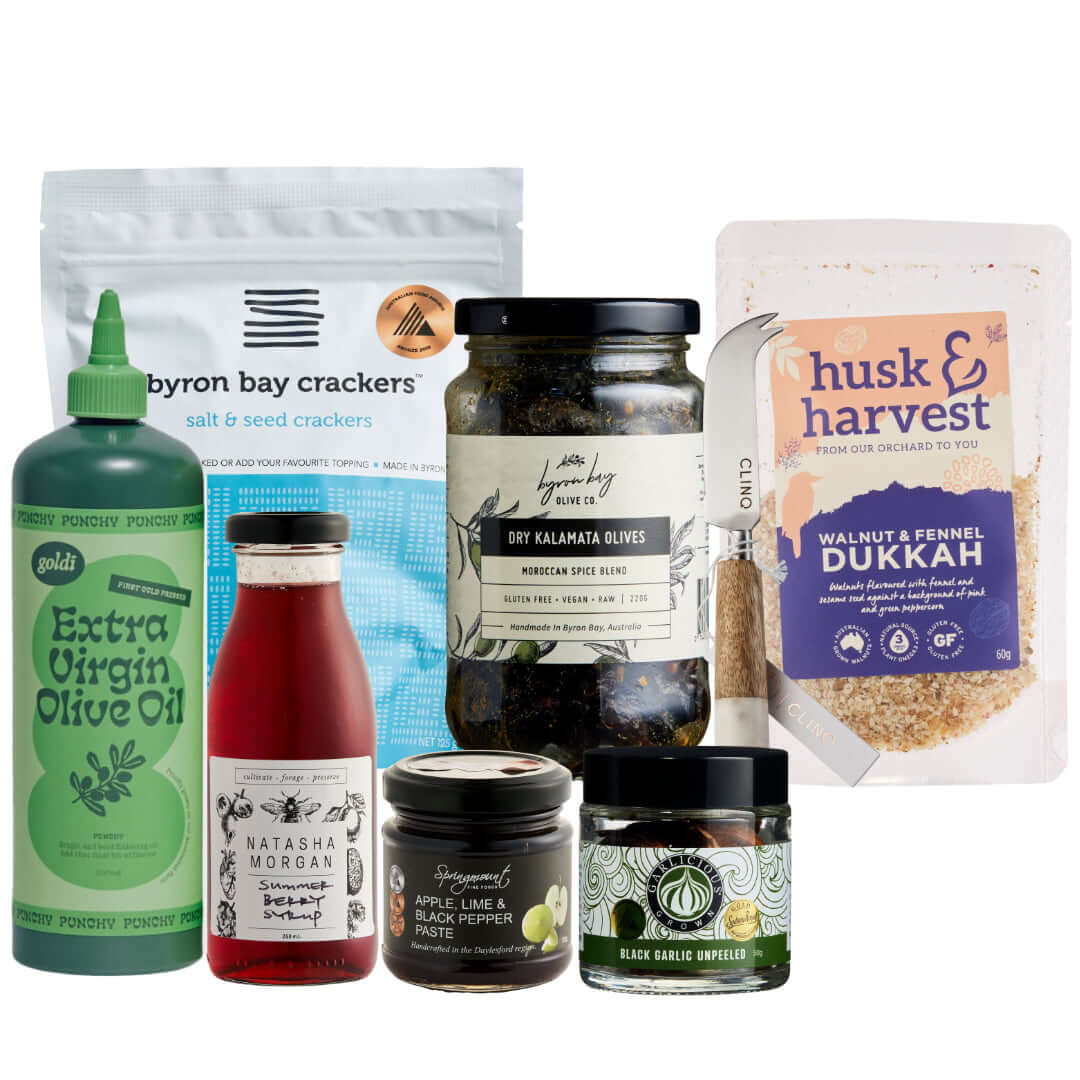 Gourmet gift box ingredients including crackers, olive oil, olives, and dukkah for a premium tasting experience.