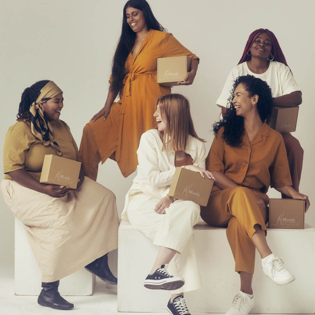 Alt text:
Women from social enterprise Mettle in Perth holding branded gift boxes, showcasing purpose-driven products handmade by women rebuilding their lives after domestic and family violence.