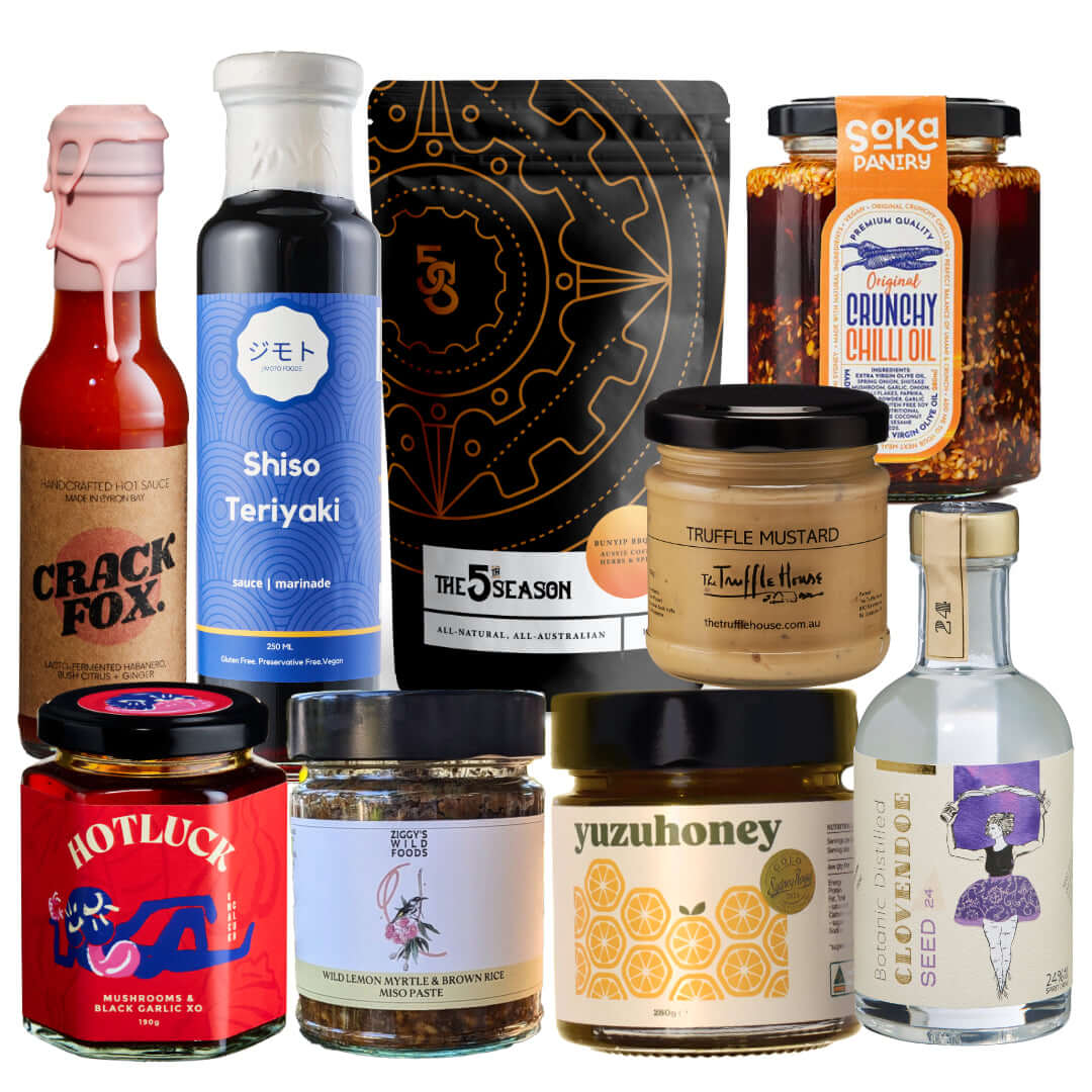 Selection of gourmet sauces and condiments including chili oil, truffle mustard, and specialty honeys in a colorful arrangement.