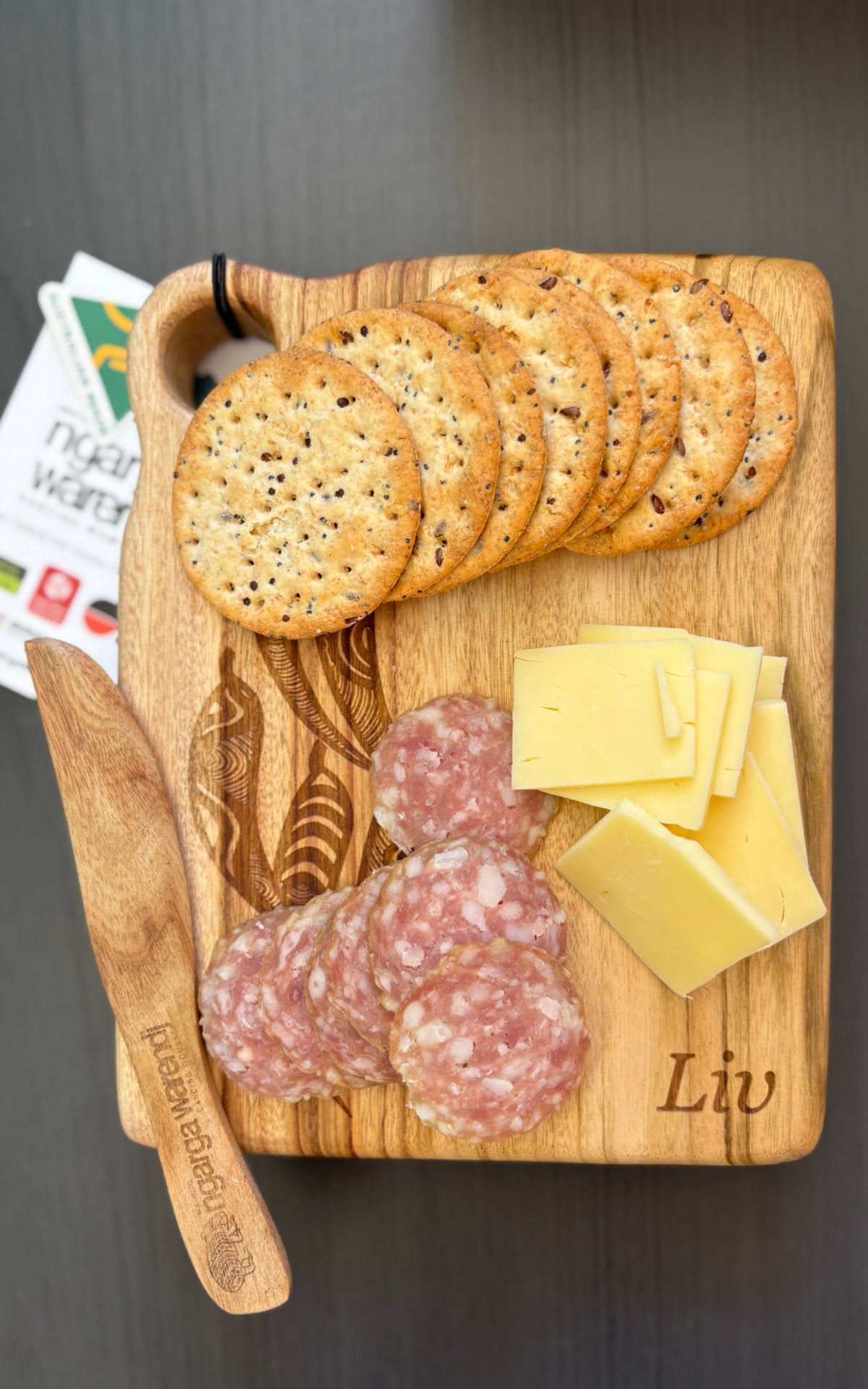 Personalised Ngarga Warendj timber cheeseboard featuring crackers, cheese and cured meats, created for Adobe team gifting.